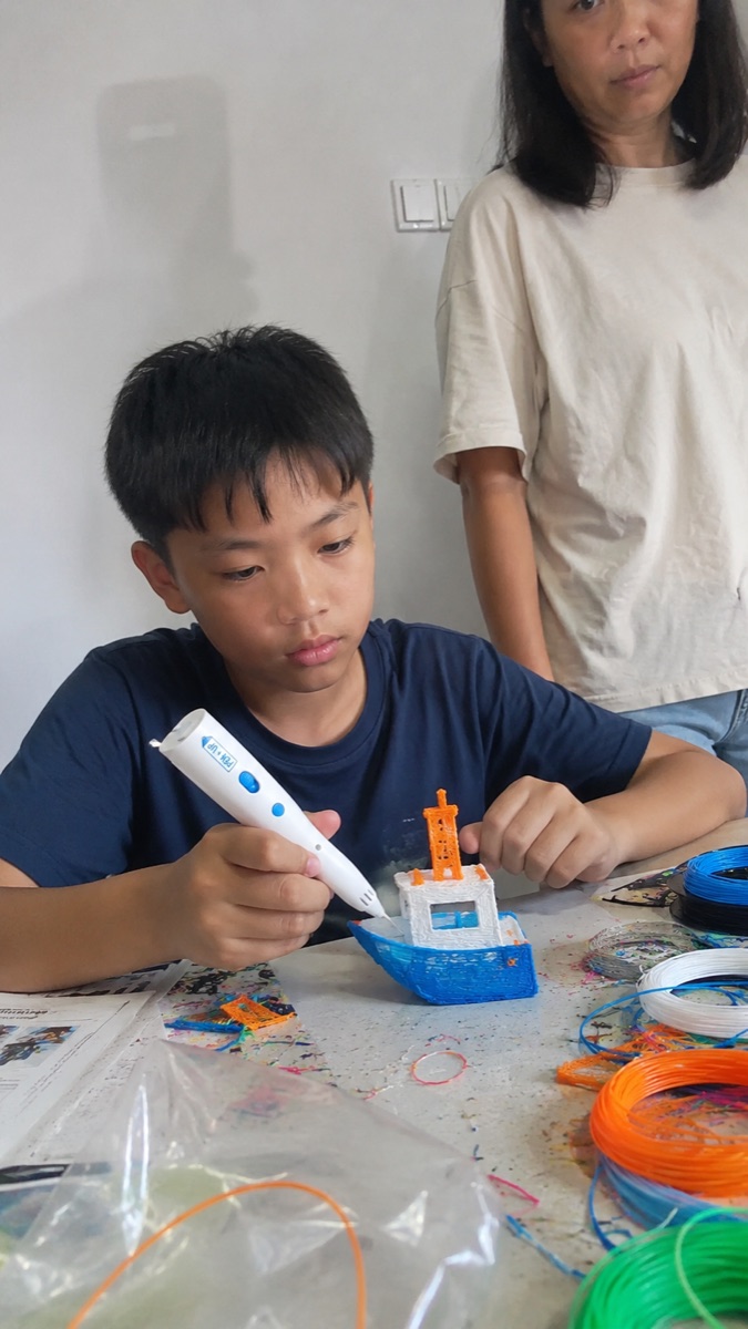 Una niña sonríe sujetando el bolígrafo 3D Pen'Up 3D y su creación